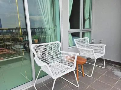 two white chairs and a table on a balcony at D3911 Klcc View Private Roof Terrace l 8Pax in Kuala Lumpur