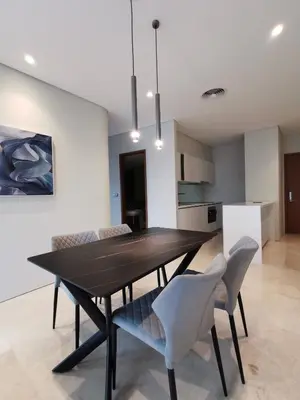 a dining room with a black table and chairs at Sky Suites KLCC by Deep Sleep in Kuala Lumpur