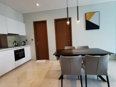 a kitchen and dining room with a table and chairs at Sky Suites KLCC by Deep Sleep in Kuala Lumpur