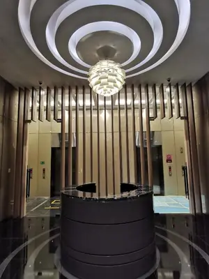 a lobby with a large chandelier in a building at Sky Suites KLCC by Deep Sleep in Kuala Lumpur