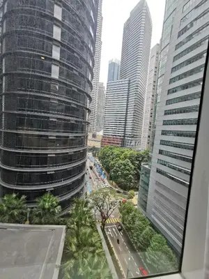 a view from a window of a city with tall buildings at Sky Suites KLCC by Deep Sleep in Kuala Lumpur