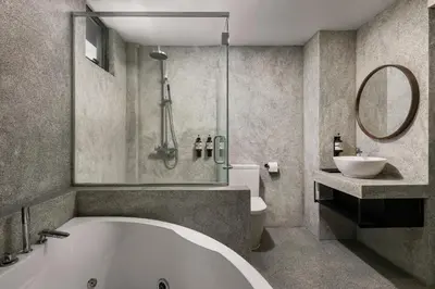 a bathroom with a tub and a toilet and a sink at BRYQS Hotel KL Sentral in Kuala Lumpur