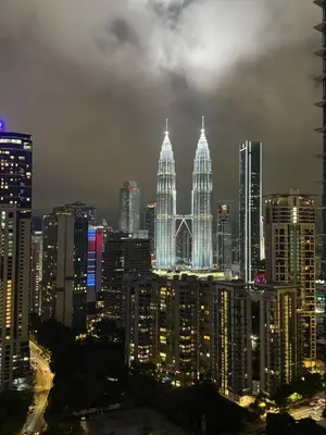 a city skyline at night with tall buildings at Eaton Residences KLCC By ARBAN in Kuala Lumpur