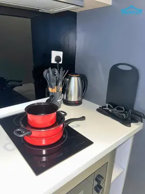 a red frying pan on a stove in a kitchen at The Robertson Bukit Bintang KLCC by Dream'Inn in Kuala Lumpur