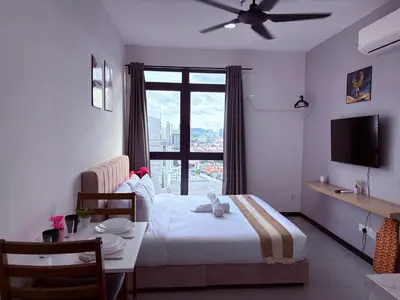 a bedroom with a bed and a table and a window at Luxury Studio - City View - LRT - KLCC - KL - Gleneagles in Kuala Lumpur