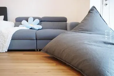 a blue couch with a white flower on top of it at Vivo Suite 4 pax 2 bed Studio in Kuala Lumpur