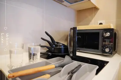 a kitchen counter with a knife block and a microwave at Vivo Suite 4 pax 2 bed Studio in Kuala Lumpur