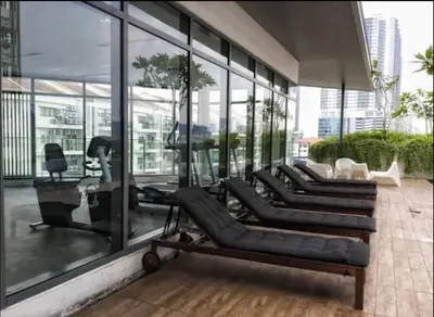 a lobby with black leather furniture and glass windows at Vivo Suite 4 pax 2 bed Studio in Kuala Lumpur