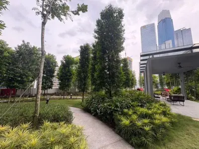 a park with a pavilion and a tree and bushes at Agile Residence Service Suites Bukit Bintang KL in Kuala Lumpur