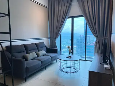 a living room with a couch and a table at Reizz by Aayu Residences - 10mins to KLCC, 2 mins to Gleneagles Hospital in Kuala Lumpur