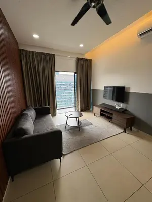a living room with a couch and a television at Reizz by Aayu Residences - 10mins to KLCC, 2 mins to Gleneagles Hospital in Kuala Lumpur