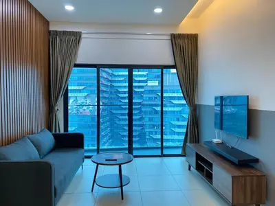 a living room with a couch and a large window at Reizz by Aayu Residences - 10mins to KLCC, 2 mins to Gleneagles Hospital in Kuala Lumpur