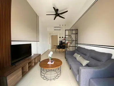 a living room with a blue couch and a tv at Reizz by Aayu Residences - 10mins to KLCC, 2 mins to Gleneagles Hospital in Kuala Lumpur