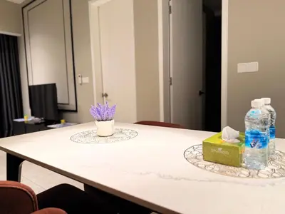 a table with a bottle of water and a box of tissues at Residensi Akson Bukit Bintang Axon nearby Pavilion TRX in Kuala Lumpur