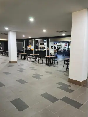 a large room with tables and chairs in a building at Spacious 2 bedrooms 10 mins to Bukit Bintang in Kuala Lumpur