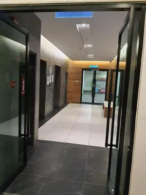 an empty hallway of an office building with glass doors at Spacious 2 bedrooms 10 mins to Bukit Bintang in Kuala Lumpur