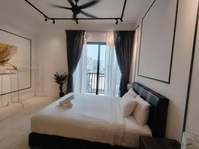 a bedroom with a large bed with a window at Chambers Skypool KLCC in Kuala Lumpur