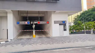 a parking garage with a red traffic light in a building at Chambers Skypool KLCC in Kuala Lumpur