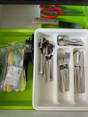 a white container filled with utensils on a table at INFINITUM suites KLCC , infinity pool 360 view in Kuala Lumpur