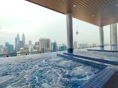 a swimming pool on the roof of a building at INFINITUM suites KLCC , infinity pool 360 view in Kuala Lumpur