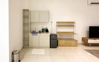 a kitchen with a small refrigerator and a counter at 3 Towers Jln Ampang by Airhost in Kuala Lumpur