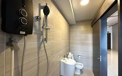 a bathroom with a shower and a toilet in it at 3 Towers Jln Ampang by Airhost in Kuala Lumpur