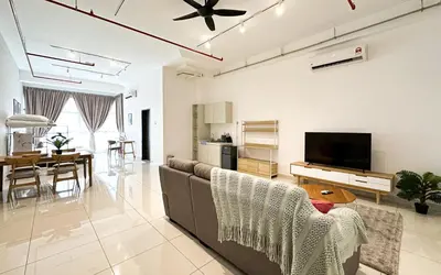 a living room with a couch and a dining room at 3 Towers Jln Ampang by Airhost in Kuala Lumpur