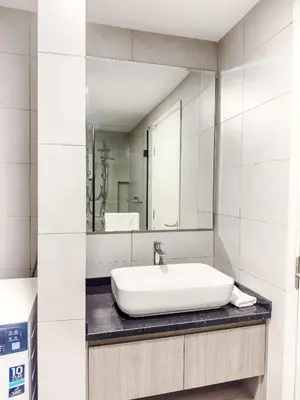 a white bathroom with a sink and a mirror at The Atrium at Jalan Ampang by OKBnB - Classy Vibes 2Bedroom Apartment nearby KLCC , Pavilion & TRX in Kuala Lumpur