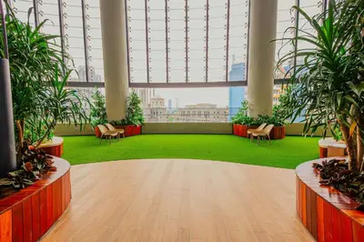 a large room with plants and chairs in a building at The Atrium at Jalan Ampang by OKBnB - Classy Vibes 2Bedroom Apartment nearby KLCC , Pavilion & TRX in Kuala Lumpur