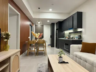 a kitchen and living room with a couch and a table at The Atrium at Jalan Ampang by OKBnB - Classy Vibes 2Bedroom Apartment nearby KLCC , Pavilion & TRX in Kuala Lumpur