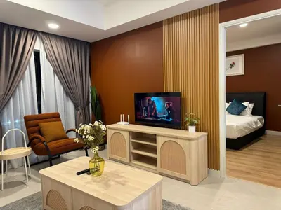 a living room with a television and a bed at The Atrium at Jalan Ampang by OKBnB - Classy Vibes 2Bedroom Apartment nearby KLCC , Pavilion & TRX in Kuala Lumpur