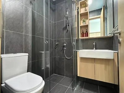 a bathroom with a shower and a toilet and a sink at The Luxe by Infinitum Suites in Kuala Lumpur