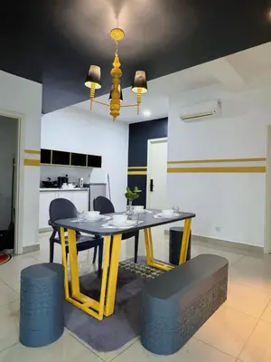 a dining room with a yellow table and chairs at Comfy Arte Plus Ampang KL City 8 Pax-3BR-2CP in Kuala Lumpur
