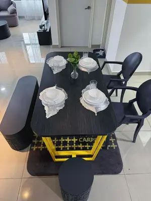 a black table with chairs and plates on it at Comfy Arte Plus Ampang KL City 8 Pax-3BR-2CP in Kuala Lumpur