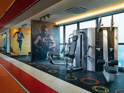 a gym with tread machines and a poster on the wall at Comfy Arte Plus Ampang KL City 8 Pax-3BR-2CP in Kuala Lumpur