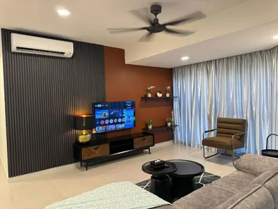 a living room with a couch and a flat screen tv at The Atrium at Jalan Ampang by OKBnB - Classy 3Bedroom Family Suite nearby KLCC , TRX and Pavilion KL in Kuala Lumpur