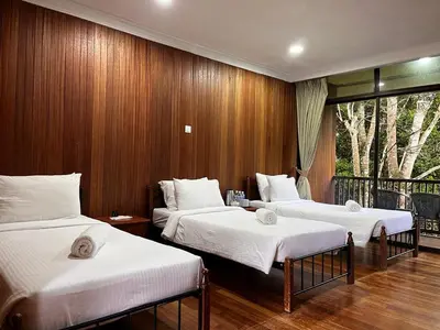 three beds in a room with wooden walls at Kl Gateway in Kuala Lumpur