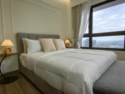 a bedroom with a large bed with a large window at TRX Agile Bukit Bintang Boutique 2 Bedroom and 1 Living Room Suites in Kuala Lumpur