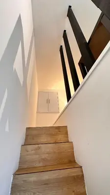 a staircase in a house with wooden floors at The Establishment Bangsar #23a by Ouki in Kuala Lumpur