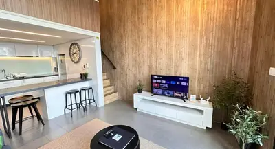 a living room with a kitchen and a tv on a counter at The Establishment Bangsar #2216 by Ouki in Kuala Lumpur