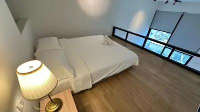 a bedroom with a white bed and a lamp at The Establishment Bangsar #29 by Ouki in Kuala Lumpur
