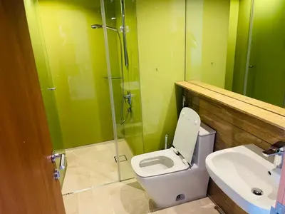 a bathroom with a toilet and a shower and a sink at Ludy House in Kuala Lumpur