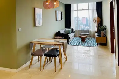 a living room with a table and a couch at Ludy House in Kuala Lumpur