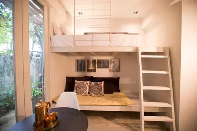 a room with bunk beds and a table at M1- room w planter box in Kuala Lumpur