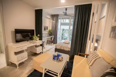 a living room with a desk and a bedroom at M1- room w planter box in Kuala Lumpur