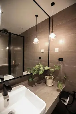 a bathroom with a sink and a mirror at M1- room w planter box in Kuala Lumpur