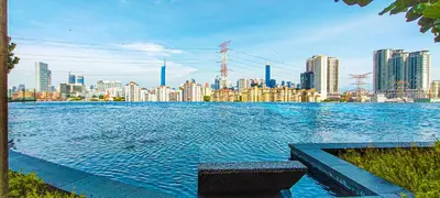 a large pool of water with a city in the background at M Vertica in Kuala Lumpur