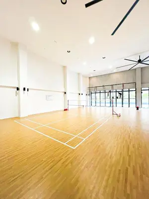 a tennis court with a wooden floor in a room at M Vertica in Kuala Lumpur