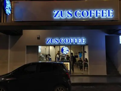 a car parked in front of a zus coffee store at M Vertica in Kuala Lumpur