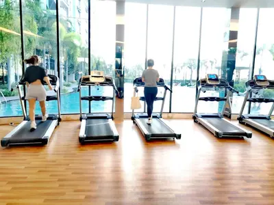 a group of people on treadmills in a gym at TRION Luxury City Suites Near KLCC & TRX in Kuala Lumpur